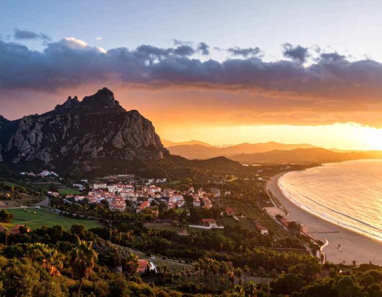a town on a hill next to a beach