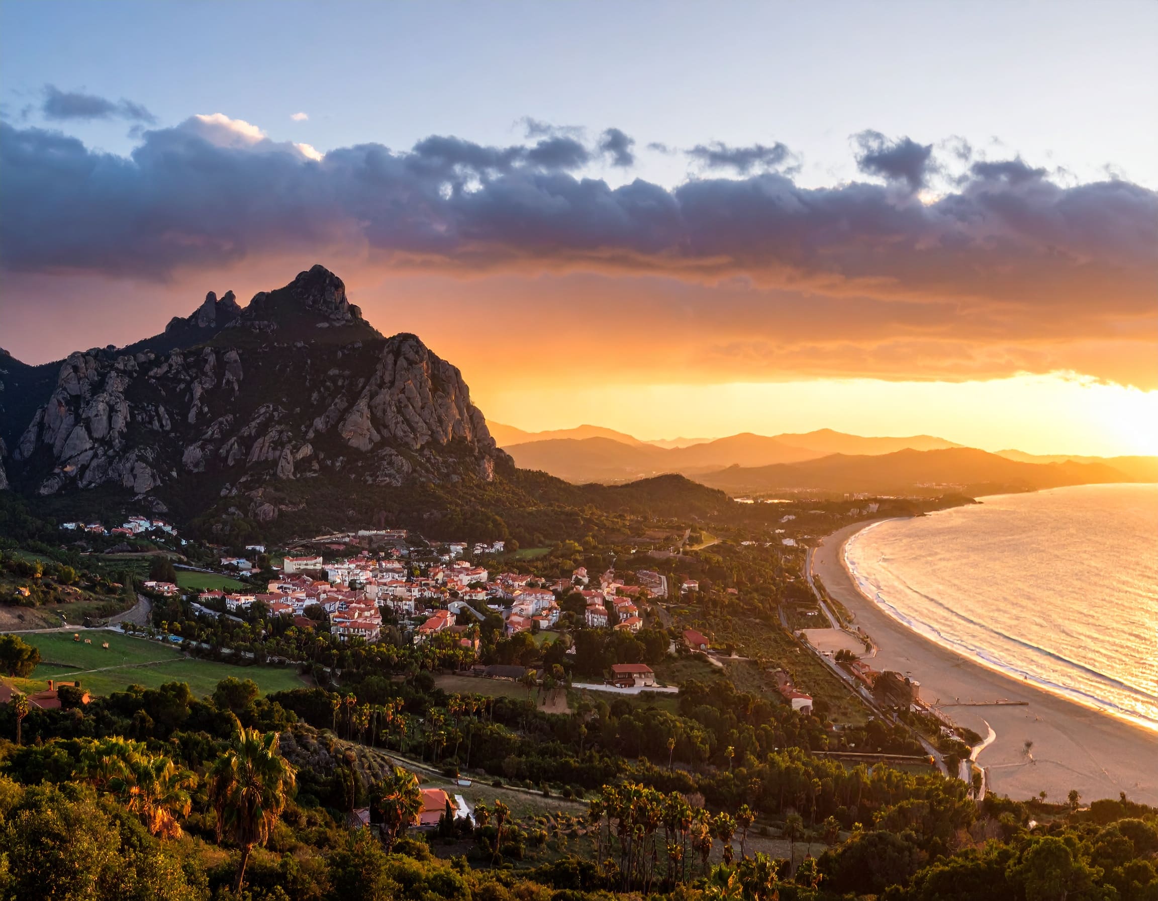 a town on a hill next to a beach