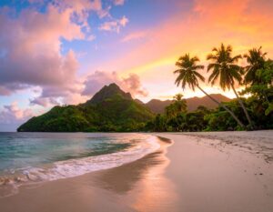 Sonnenaufgang über Maracas Beach mit Palmen, weißem Sand, türkisfarbenem Meer und Regenwaldhügeln im Hintergrund.